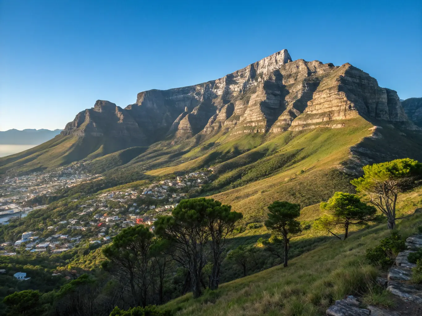 A stunning photograph of Table Mountain in Cape Town, South Africa, bathed in the golden light of sunset, representing the scenic beauty of Southern Africa.
